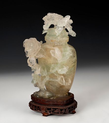 Potiche with flowers. China, XX century. 
Hand-carved translucent jade on wooden base.