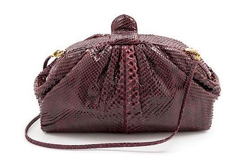 * A Judith Leiber Maroon Snakeskin Handbag, 10.5" x 6" x 3.5".