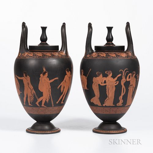 Pair of Encaustic Decorated Black Basalt Vases and Covers, England, 19th century, urn finials and upturned loop handles, iron red and black figures be