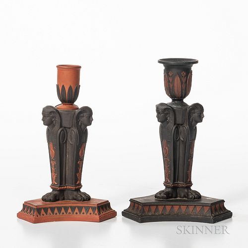 Two Similar Wedgwood Egyptian Candlesticks, England, early 19th century, a rosso antico with black basalt relief and a black basalt with rosso antico 