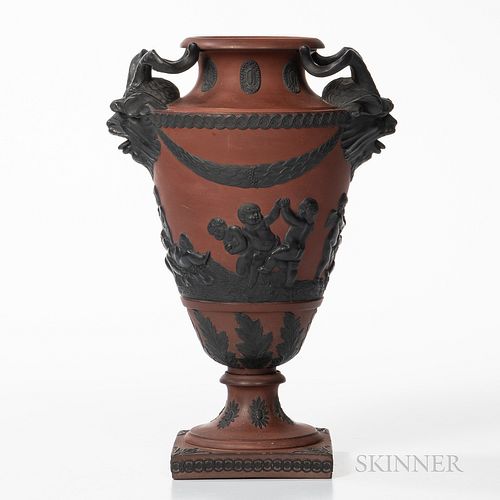 Rosso Antico Vase, England, early 19th century, possibly Spode, applied black basalt relief including goat mask and horn handles, laurel and berry fes