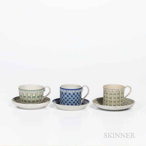 Three Wedgwood Tricolor Diceware Jasper Dip Cups and Saucers, England, early to mid-19th century, each with applied white relief, two with green groun