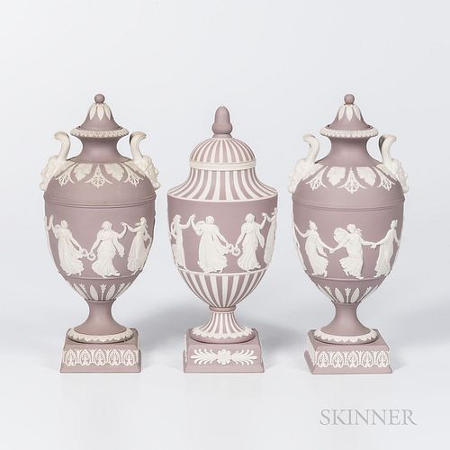 Three Wedgwood Solid Lilac Jasper Vases and Covers, England, 1960-61, each with applied white Dancing Hours in relief, a pair with Bacchus head handle