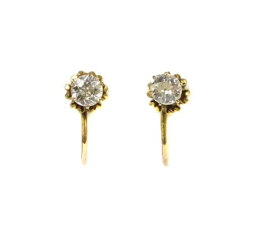 A pair of gold single diamond earrings,
