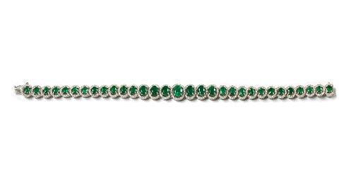 A white gold emerald and diamond bracelet,