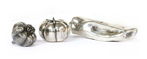 Three silver models of vegetables,