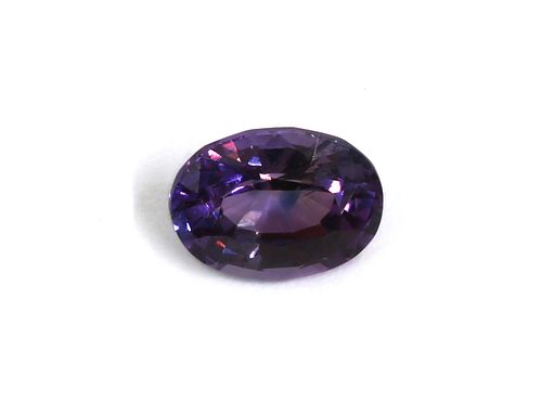 An unmounted oval mixed cut purple sapphire,