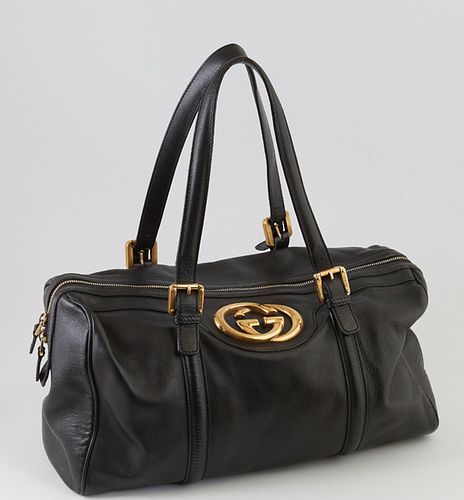 Gucci Black Smooth Leather Britt Boston Shoulder Bag, the exterior with golden brass hardware and large Gucci logo, the top zipper opening to a green 
