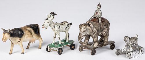 Four cast iron animals on wheels pull toys