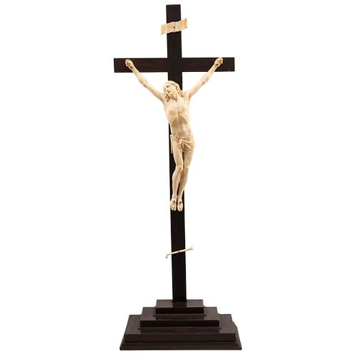 CRUCIFIED CHRIST, EARLY 19TH CENTURY, Carved in ivory, Conservation details, Christ: 17.7 x 11" (45 x 28 cm), Cross: 37.7 x 13.7" (96 x 35 cm) | CRIST
