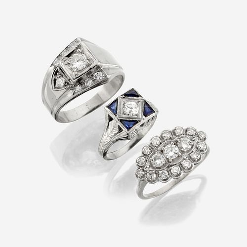 A collection of three white gold and diamond rings