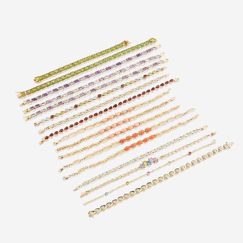 A collection of seventeen fourteen karat gold and gem-set bracelets