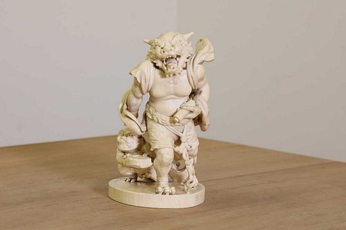 A Japanese solid carved ivory oni okimono,