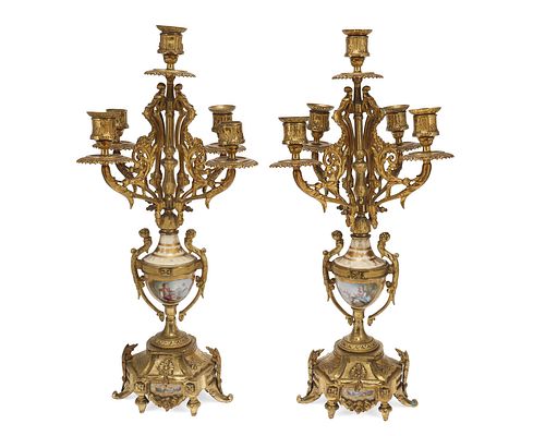 A French gilt-bronze and porcelain mantel clock and candelabra set