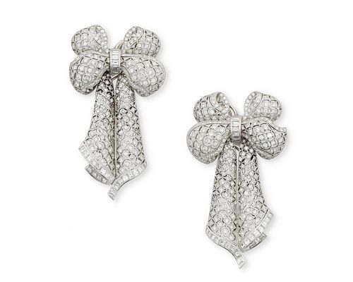 A pair of diamond bow ear pendants