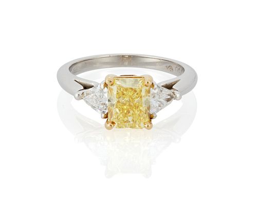 A fancy vivid yellow diamond ring