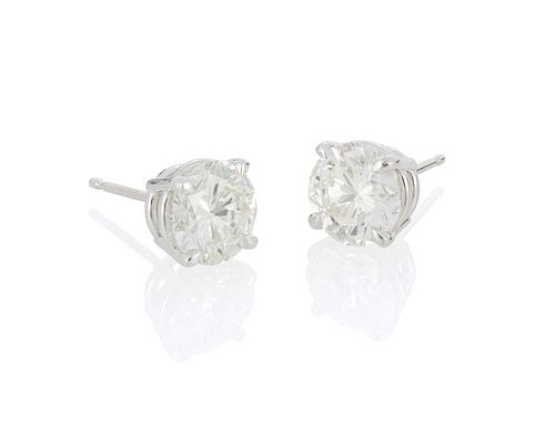 A pair of diamond stud earrings with jackets