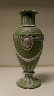 A Wedgwood three colour jasper vase, the green ovoid body with two classical profiles in white on ma