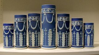 A garniture of seven early 20th century Wedgwood blue jasper spill vases, each with floral swags sus