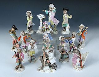 A Meissen fifteen piece monkey band, each of the figures singing or playing an instrument, a drummer