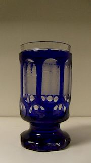A mid 19th century Bohemian blue overlay tumbler, seven of the eight oval windows to the cylindrical