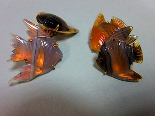A pair of carved agate angel fish double ended cufflinks, each shaped piece of translucent banded ag