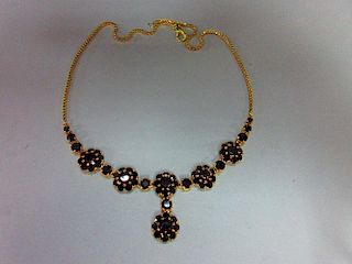 A Bohemian garnet cluster necklace, composed of five flowerhead clusters of round cut garnets, suspe
