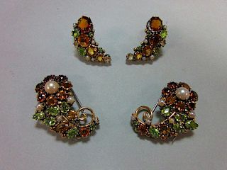 A suite of mid 20th century multi gem set dress clips and earrings believed to be by Dorrie Nossiter