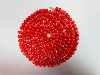 A long red coral bead necklace, the individually-knotted tyre shaped coral beads of approximately 8m