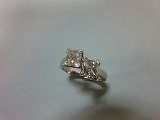 A certificated two stone princess cut diamond and platinum ring, the two beautifully matched stones,