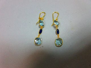A pair of aquamarine and sapphire earrings, each gold wire hook suspending an articulated line of th