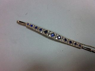 An Art Deco sapphire and diamond bracelet, set to the centre with an articulated and graduated line