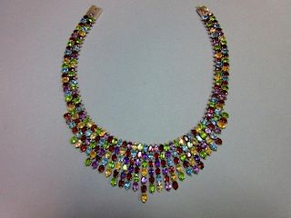 A multi gemset collar necklace, designed as close set lines of similarly sized oval cut garnets, ame