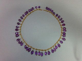 An amethyst fringe necklace, the unmarked yellow precious metal belcher link chain suspending evenly