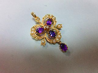 A gold, amethyst, seed pearl and diamond pendant / brooch, designed as an open trefoil delineated wi