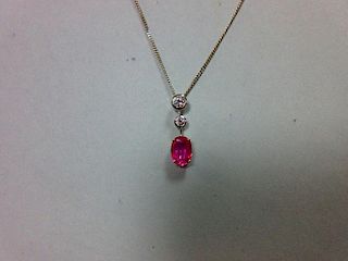 A pink sapphire and diamond pendant set in 18ct white gold, designed as a line of three stones separ