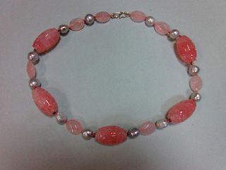 A carved rose quartz and pearl necklace, composed of five barrel shaped carved rose quartz beads spa