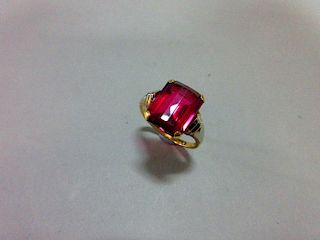 An Austrian single stone synthetic red spinel ring, the fancy cut rectangular pinky-red spinel, claw