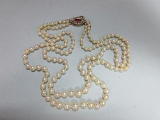 A two row pearl necklace with ruby and diamond clasp, the 3.6 - 8.0mm graduated pearls, to a navette