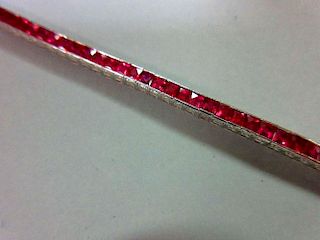 A ruby line bracelet, the square cut rubies channel set in a smooth continuous line of cubic links,