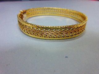 An Austrian 14ct gold bracelet, the delicate pierced polished and textured ribbon band, width 1cm, t