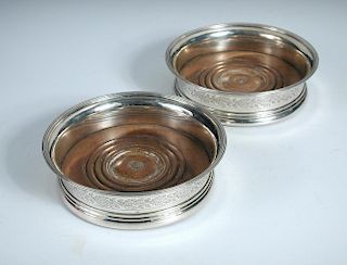 A pair of George III silver wine coasters, by John Emes, London 1803, each circular with moulded foo