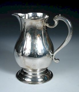 A George II silver ale jug, by Jonathan Fossy, London 1742, of plain baluster form over a spreading