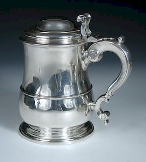 A George II silver tankard, by Lewis Hamon, London 1737, of plain baluster form with moulded edge an