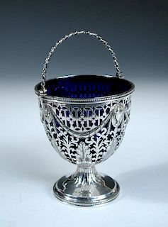 A George III silver sugar basket, by John Edwards III, London 1804, of vase shape the body festooned