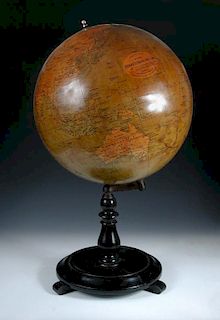 A Philips' 19 inch terrestial globe, with dark varnished gores, on an ebonised turned wood stand 81c
