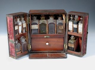 A 19th century mahogany apothecary's chest, the thirteen bottles mainly bearing labels for 'R Hempst
