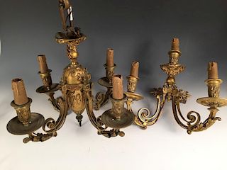 A late 19th/early 20th century bronze four branch ceiling light and matching wall light, each featur