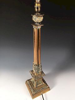 A 19th century gothic brass column lamp later converted as an electric lamp, the bowl nozzle on four