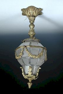 A modern brass mounted and frosted glass hall lantern, the pear shaped facetted glass shade mounted